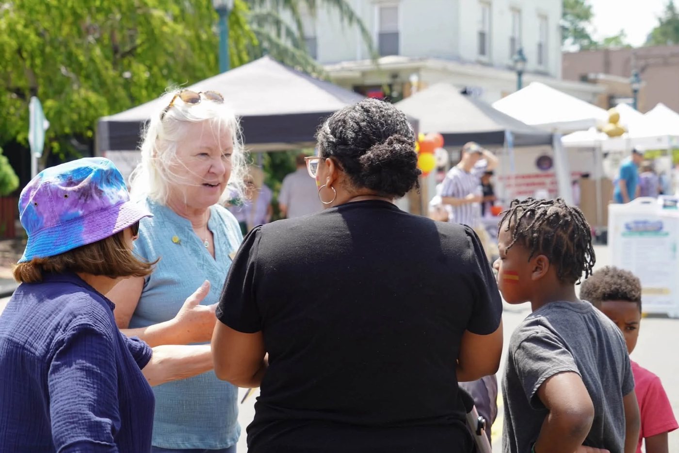 Susan Bloom talking with residents and children at a Clarkstown street fair